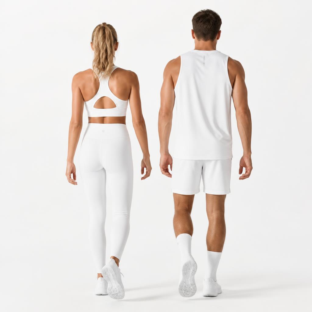 Two athletes in white activewear walking away from camera